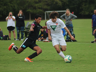 A Group Of People Playing Football On A Field