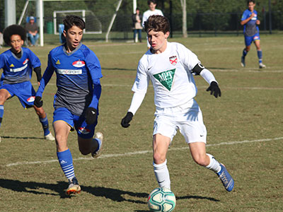 A Group Of Young Men Playing A Game Of Football