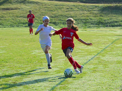A Group Of People Playing Football On A Field