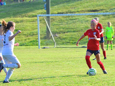 A Group Of People Playing Football On A Field