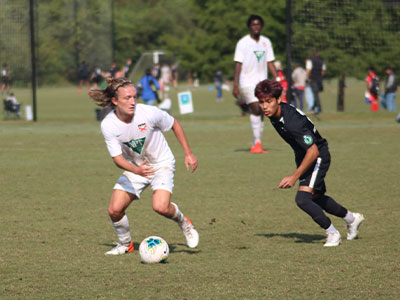 A Group Of Young Men Playing A Game Of Football